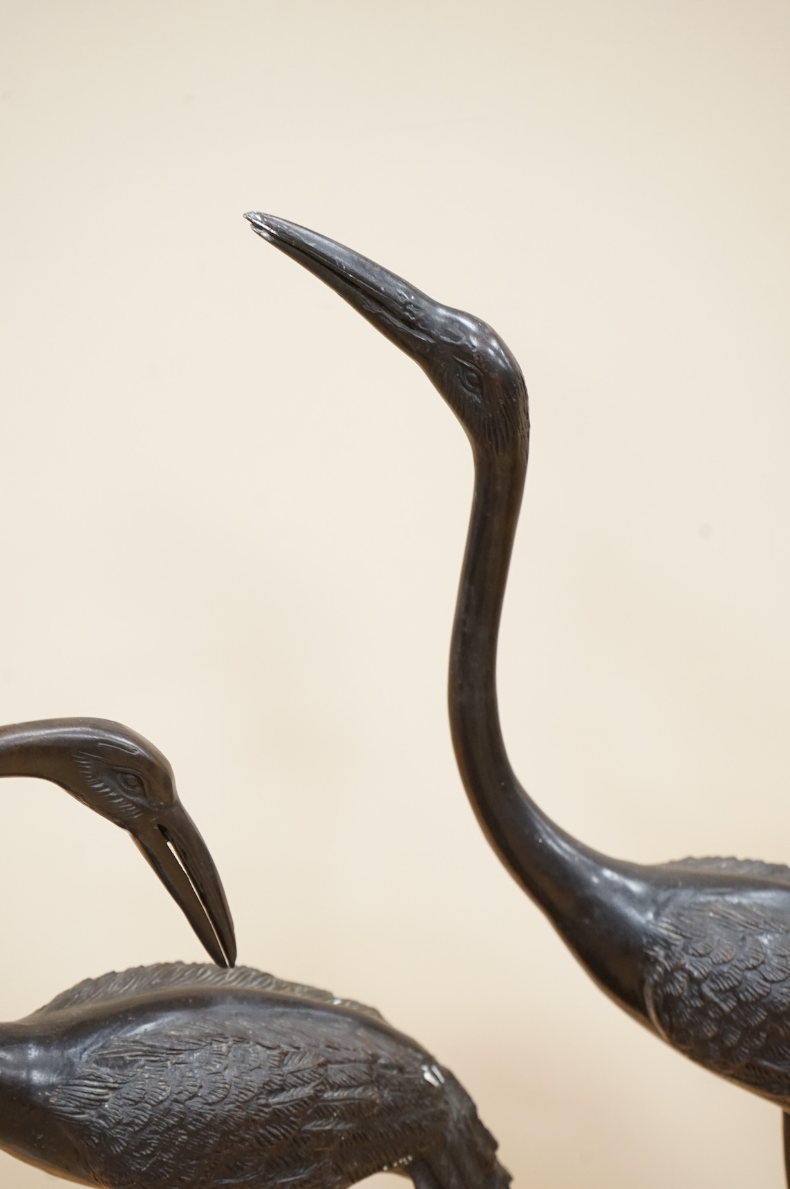 A pair of patinated bronze cranes, 62cm